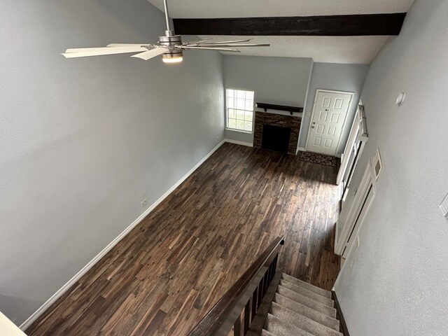 2510 Grants Lake Blvd Unit 101, Sugar Land, TX 77479 - unfurnished living room with a ceiling fan, dark wood-type flooring, a fireplace, and stairs
