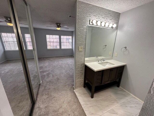 2510 Grants Lake Blvd Unit 101, Sugar Land, TX 77479 - bathroom featuring ceiling fan, a textured ceiling, and vanity