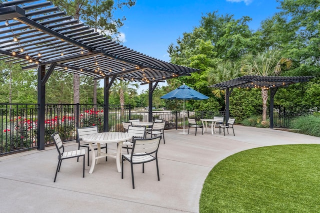 134 Biltmore Loop, Montgomery, TX 77316 - view of patio with a pergola, outdoor dining area, and view of wooded area
