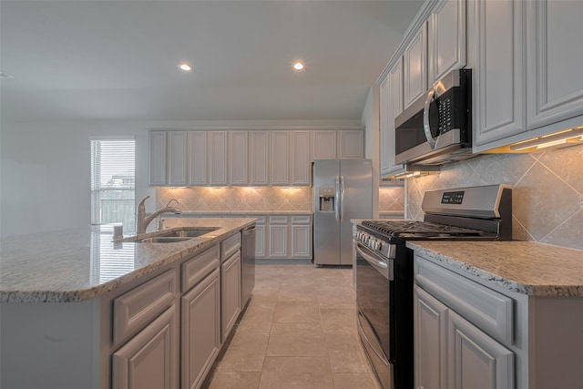 8326 Erasmus Landing Ct, Houston, TX 77044 - kitchen featuring stainless steel appliances, backsplash, gray cabinets, recessed lighting, and light stone counters
