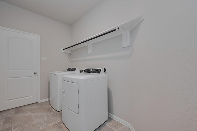 8326 Erasmus Landing Ct, Houston, TX 77044 - laundry room with washing machine and dryer and light stone finish floors