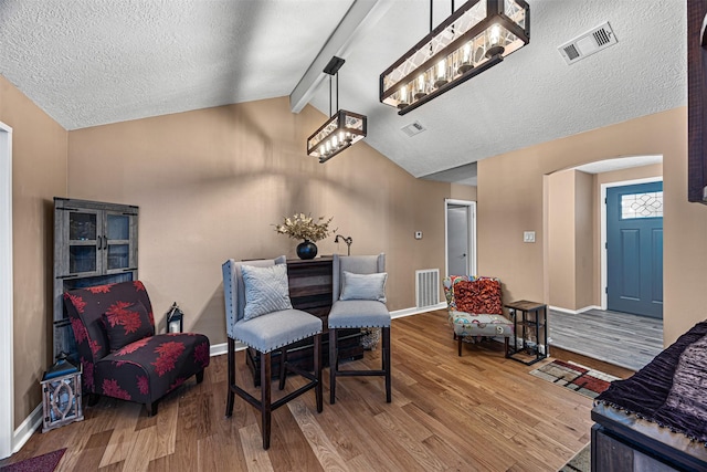 5406 Hazel St, Baytown, TX 77521 - living area featuring wood finished floors, arched walkways, and a textured ceiling