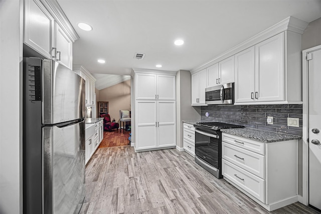 5406 Hazel St, Baytown, TX 77521 - kitchen featuring stainless steel appliances, white cabinetry, light stone countertops, light wood finished floors, and recessed lighting