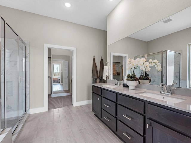 14931 Clover Meadow Ln, Montgomery, TX 77316 - full bathroom with double vanity, a marble finish shower, wood finish floors, and recessed lighting