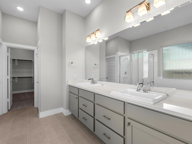 14939 Clover Meadow Ln, Montgomery, TX 77316 - bathroom featuring a shower stall, double vanity, tile patterned flooring, a spacious closet, and recessed lighting
