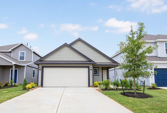 2569 Hawks Eye Dr, Conroe, TX 77301 - view of front of property with a front yard, driveway, and an attached garage