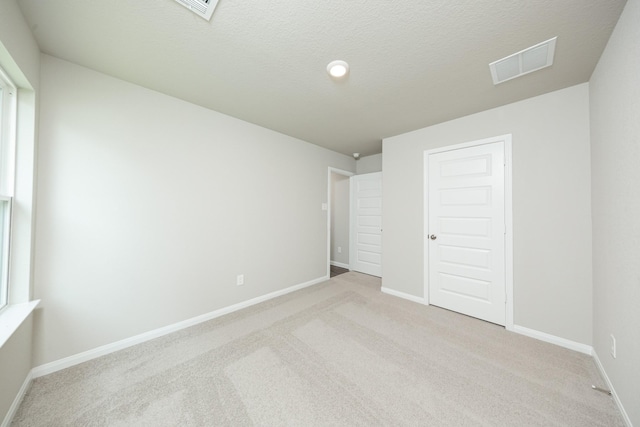 2569 Hawks Eye Dr, Conroe, TX 77301 - unfurnished bedroom with light colored carpet and a textured ceiling