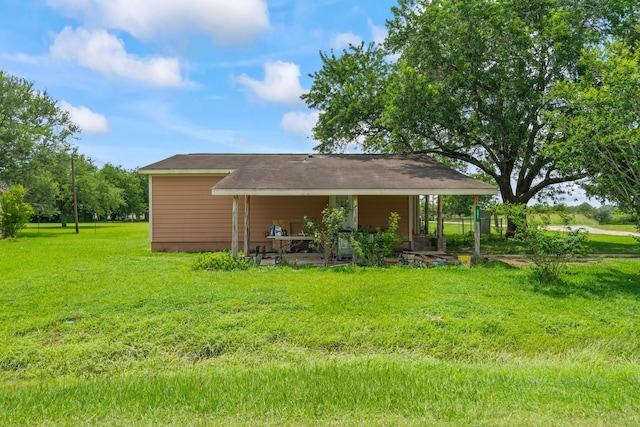 501 Carlson Cir, Wharton, TX 77488 - back of house featuring a lawn