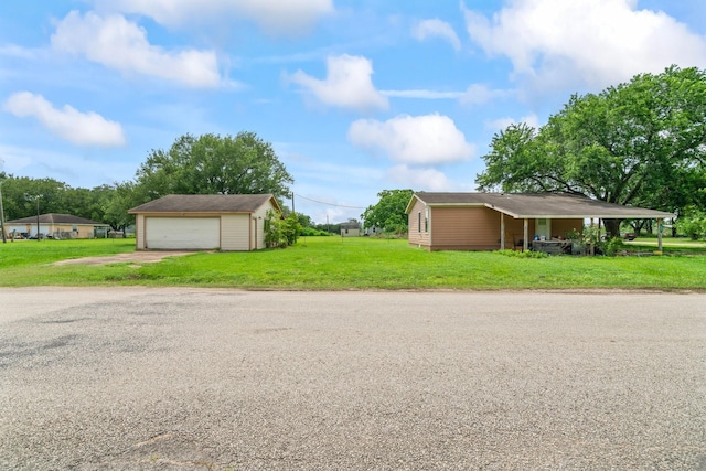501 Carlson Cir, Wharton, TX 77488 - view of home's exterior with an outbuilding, a lawn, a garage, and driveway