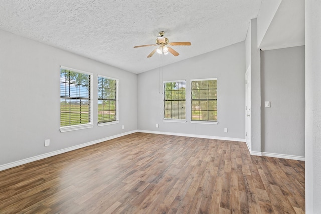 501 Carlson Cir, Wharton, TX 77488 - spare room featuring ceiling fan, vaulted ceiling, wood finished floors, and a textured ceiling