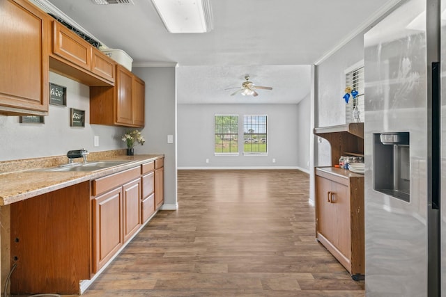 501 Carlson Cir, Wharton, TX 77488 - kitchen with stainless steel fridge, wood finished floors, ornamental molding, light countertops, and a ceiling fan