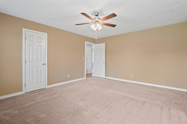 501 Carlson Cir, Wharton, TX 77488 - unfurnished bedroom with light carpet, a textured ceiling, and a ceiling fan