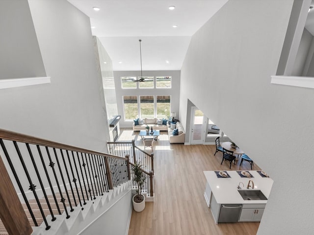 14316 Moonlit Creek Ct, Montgomery, TX 77316 - stairs with wood finished floors, ceiling fan, a high ceiling, and recessed lighting