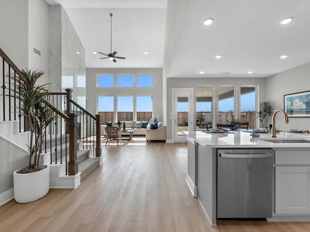 14316 Moonlit Creek Ct, Montgomery, TX 77316 - kitchen with dishwasher, a sink, a ceiling fan, open floor plan, and light countertops