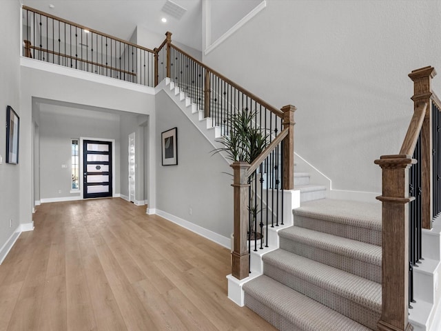 14316 Moonlit Creek Ct, Montgomery, TX 77316 - entrance foyer with stairway, light wood-style flooring, a high ceiling, and recessed lighting