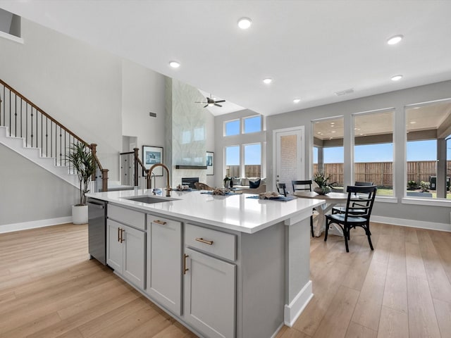 14316 Moonlit Creek Ct, Montgomery, TX 77316 - kitchen featuring a sink, stainless steel dishwasher, light wood-style flooring, baseboards, and recessed lighting
