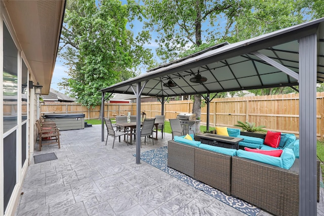 2818 Lake Forest Dr, Montgomery, TX 77356 - fenced backyard with a hot tub, a gazebo, an outdoor hangout area, a patio, and outdoor dining space