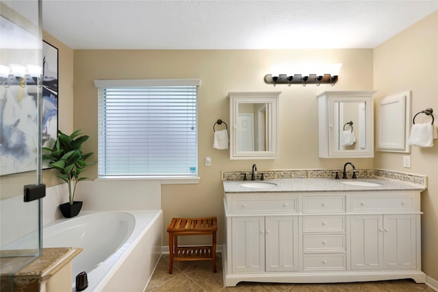 2818 Lake Forest Dr, Montgomery, TX 77356 - bathroom featuring double vanity, a garden tub, and tile patterned flooring