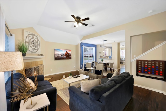 2818 Lake Forest Dr, Montgomery, TX 77356 - living room featuring wood finished floors, a ceiling fan, vaulted ceiling, and a tiled fireplace