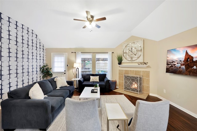 2818 Lake Forest Dr, Montgomery, TX 77356 - living room featuring vaulted ceiling, a ceiling fan, dark wood-type flooring, and a tiled fireplace