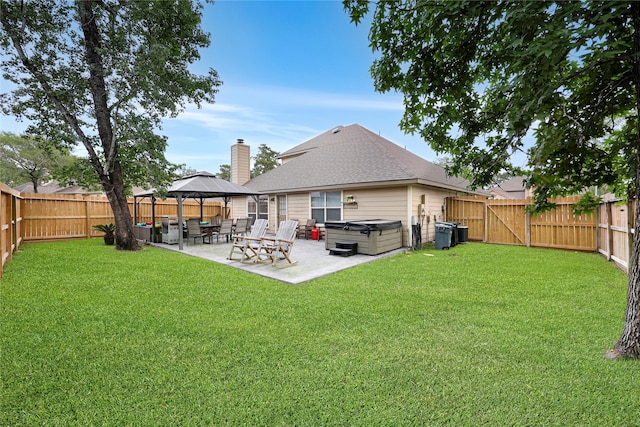 2818 Lake Forest Dr, Montgomery, TX 77356 - rear view of property with a hot tub, a patio, a fenced backyard, and a gazebo