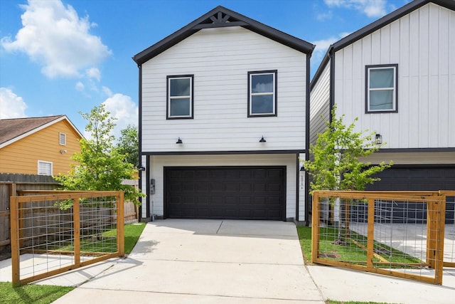2015 Brackenridge St Unit B, Houston, TX 77026 - view of front of home with an attached garage, board and batten siding, and driveway