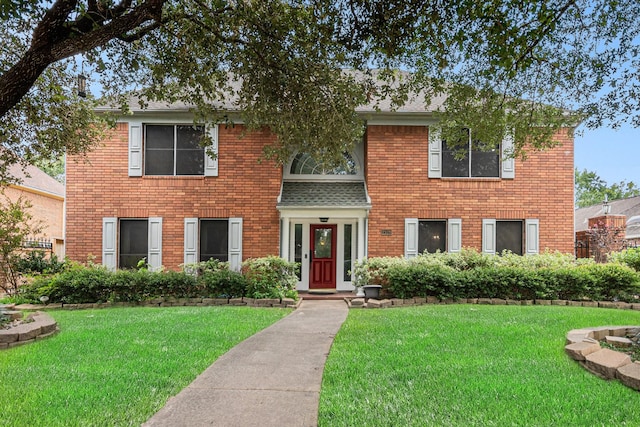 2128 Wimbleton Ct, Pearland, TX 77581 - colonial-style house with a front yard and brick siding