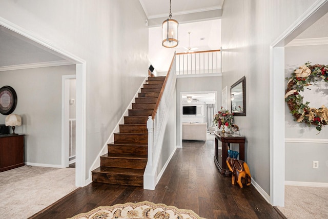2128 Wimbleton Ct, Pearland, TX 77581 - foyer with hardwood / wood-style floors, stairs, ornamental molding, and a towering ceiling