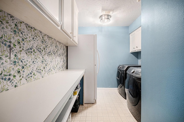 2128 Wimbleton Ct, Pearland, TX 77581 - laundry room featuring cabinet space, independent washer and dryer, a textured ceiling, and light tile patterned floors