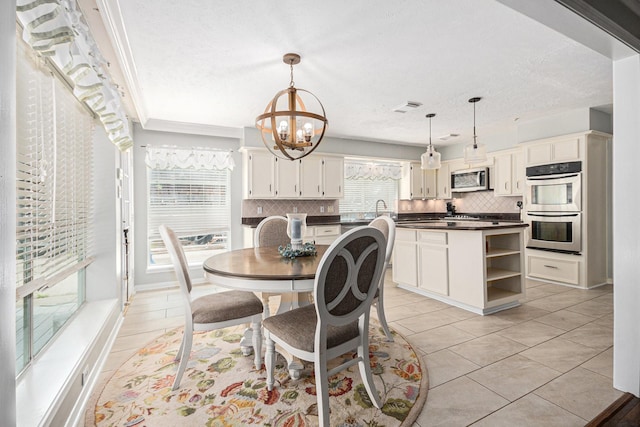 2128 Wimbleton Ct, Pearland, TX 77581 - dining area with a chandelier, light tile patterned floors, and a textured ceiling