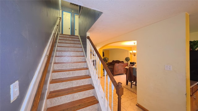 20930 Vista Trace Dr, Houston, TX 77073 - staircase featuring arched walkways, a chandelier, and tile patterned floors