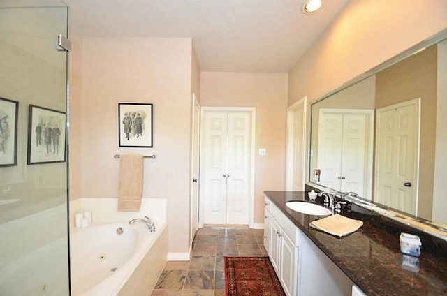 1331 W 21st St Unit A, Houston, TX 77008 - bathroom featuring a tub with jets, vanity, a closet, and recessed lighting