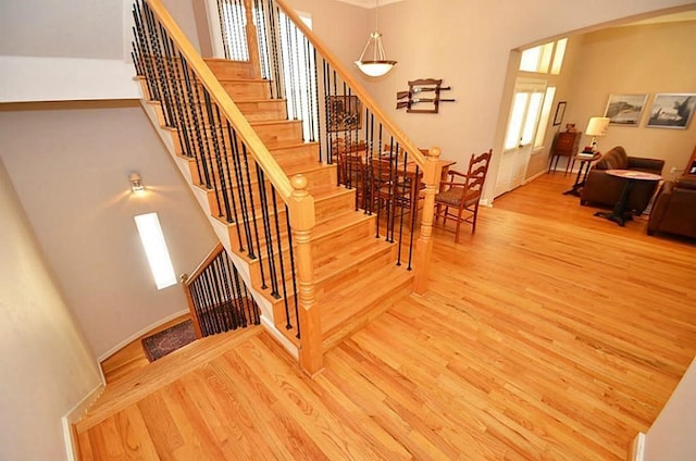 1331 W 21st St Unit A, Houston, TX 77008 - stairway featuring arched walkways, wood finished floors, and a high ceiling