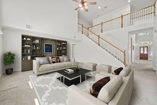 2022 Grand Willow Ln, Richmond, TX 77469 - living area with carpet, a towering ceiling, stairs, ceiling fan, and recessed lighting