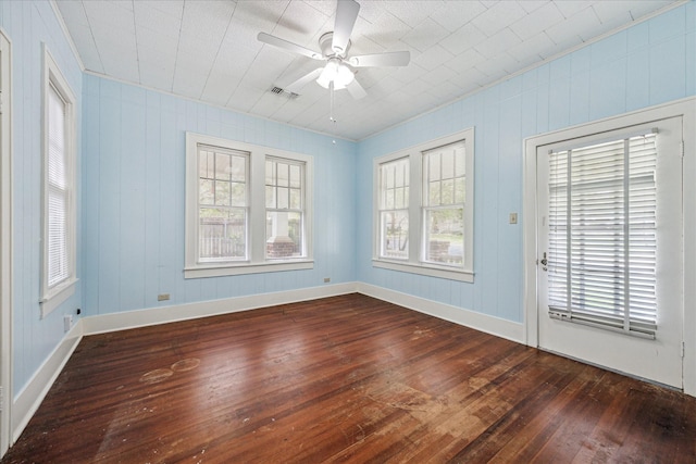 1407 S Baylor St, Brenham, TX 77833 - spare room featuring dark wood finished floors, plenty of natural light, ceiling fan, and crown molding