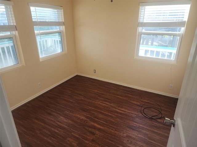 978 Nassau Ln, Crystal Beach, TX 77650 - spare room featuring healthy amount of natural light and dark wood finished floors