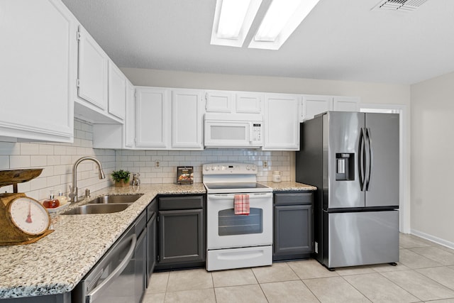 9803 Haverdown Dr, Houston, TX 77065 - kitchen with stainless steel appliances, tasteful backsplash, light tile patterned floors, and light stone countertops