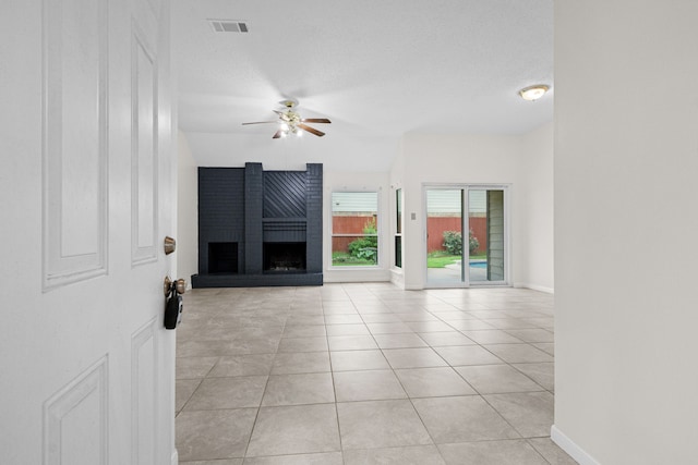9803 Haverdown Dr, Houston, TX 77065 - unfurnished living room with a ceiling fan, light tile patterned floors, and a fireplace
