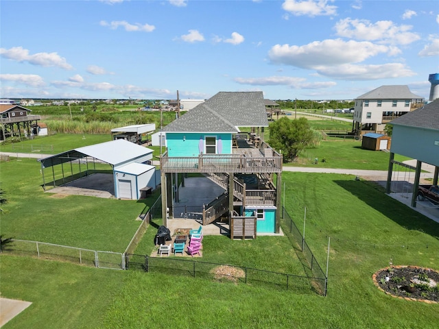 1790 Catfish Ln, Crystal Beach, TX 77650 - rear view of house with a fenced backyard, an outbuilding, stairway, a detached carport, and a deck
