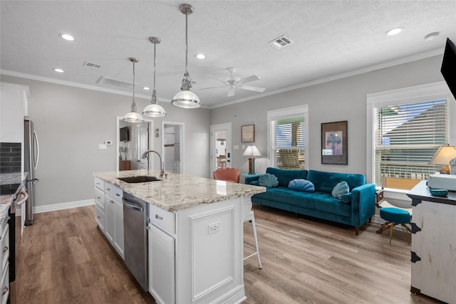 1790 Catfish Ln, Crystal Beach, TX 77650 - kitchen featuring appliances with stainless steel finishes, white cabinetry, wood finished floors, a ceiling fan, and recessed lighting