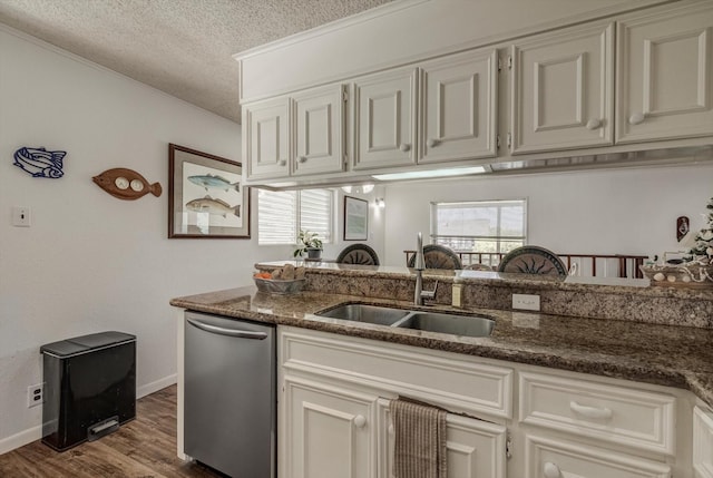 1120 Redfish St, Bayou Vista, TX 77563 - kitchen featuring dishwasher, a textured ceiling, dark stone countertops, dark wood-style floors, and plenty of natural light
