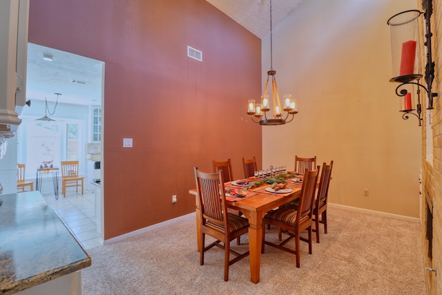 16322 Clearcrest Dr, Houston, TX 77059 - carpeted dining area with high vaulted ceiling, a chandelier, and a textured ceiling