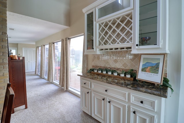 16322 Clearcrest Dr, Houston, TX 77059 - indoor dry bar with light colored carpet and backsplash