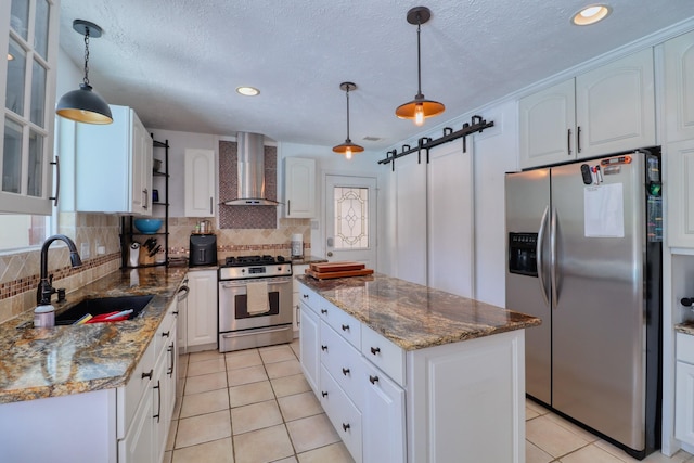 16322 Clearcrest Dr, Houston, TX 77059 - kitchen with stainless steel appliances, wall chimney range hood, a kitchen island, tasteful backsplash, and recessed lighting