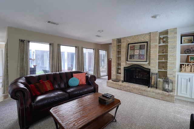 16322 Clearcrest Dr, Houston, TX 77059 - carpeted living area with built in shelves, a fireplace, and a textured ceiling