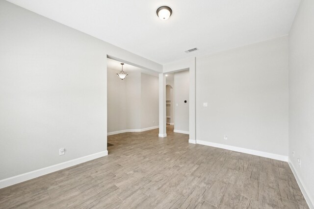 18314 Pedernales Springs Dr, Cypress, TX 77433 - empty room with arched walkways and light wood-style floors