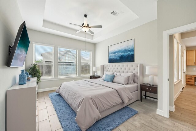 18314 Pedernales Springs Dr, Cypress, TX 77433 - bedroom with a raised ceiling, light wood-type flooring, and ceiling fan