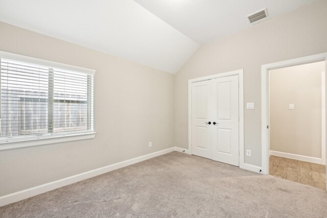 18314 Pedernales Springs Dr, Cypress, TX 77433 - unfurnished bedroom featuring carpet, lofted ceiling, and a closet