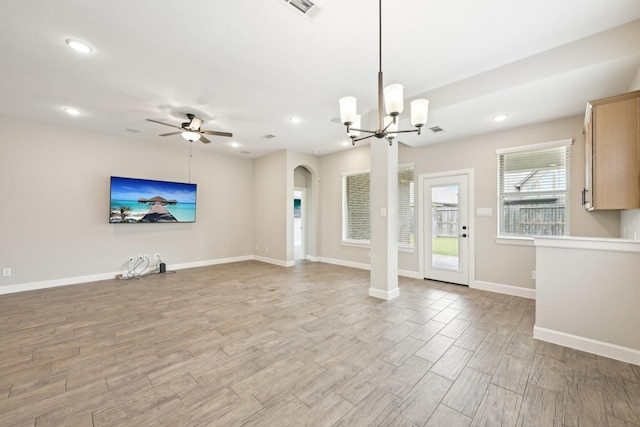 18314 Pedernales Springs Dr, Cypress, TX 77433 - unfurnished living room featuring arched walkways, a ceiling fan, a chandelier, light wood-style floors, and recessed lighting