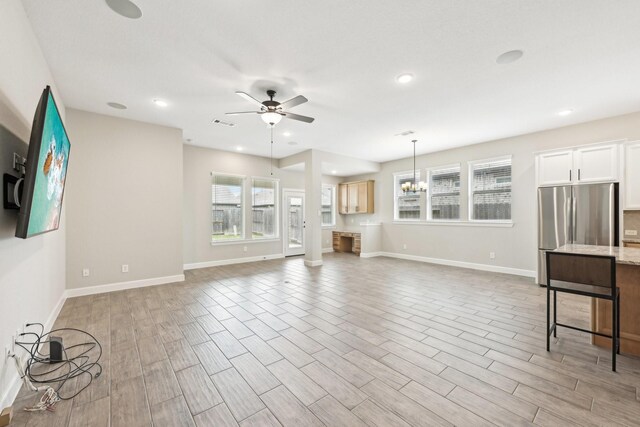 18314 Pedernales Springs Dr, Cypress, TX 77433 - unfurnished living room featuring a ceiling fan, a chandelier, light wood finished floors, and recessed lighting